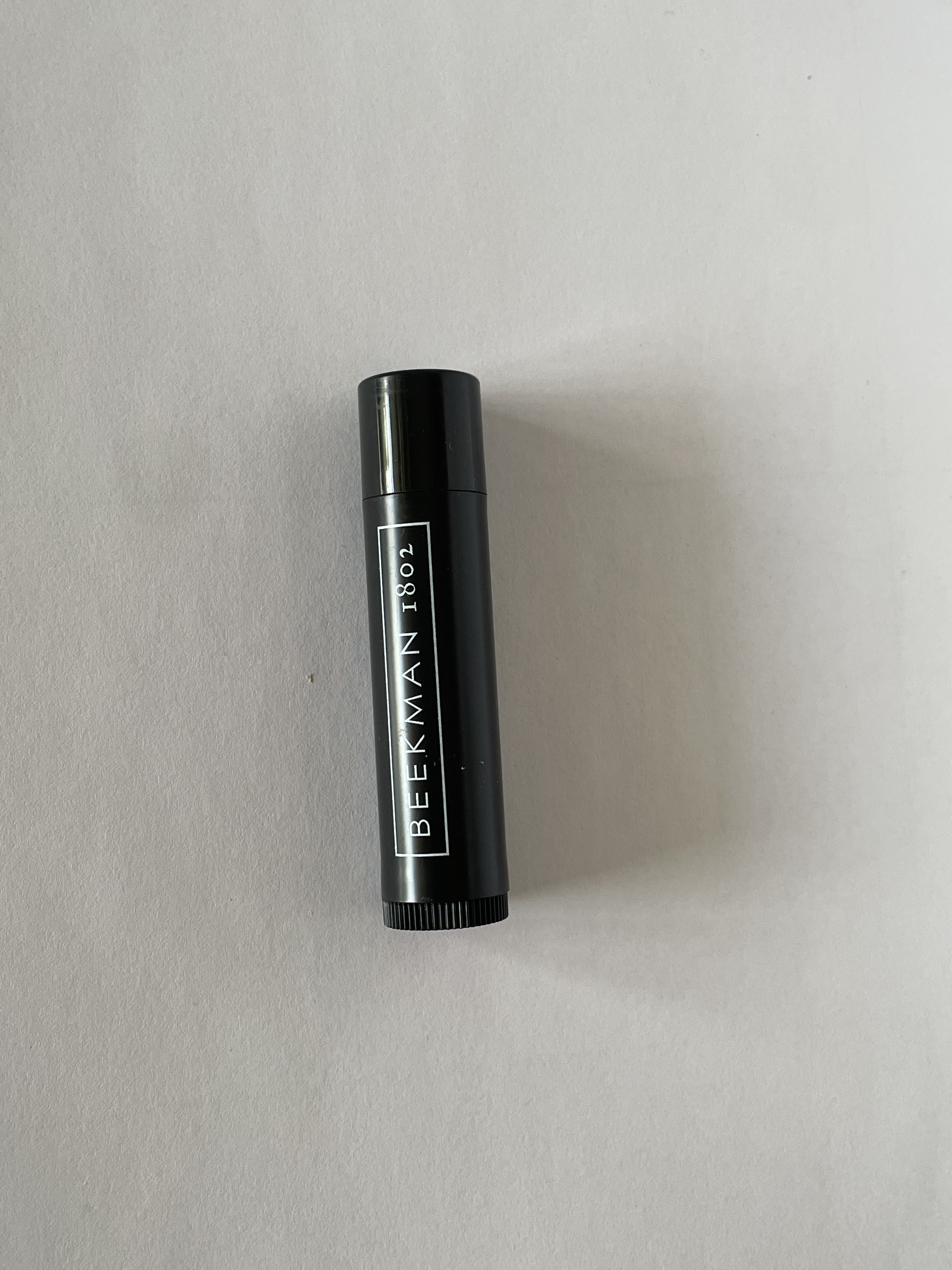 The front view of the lip balm laid down.