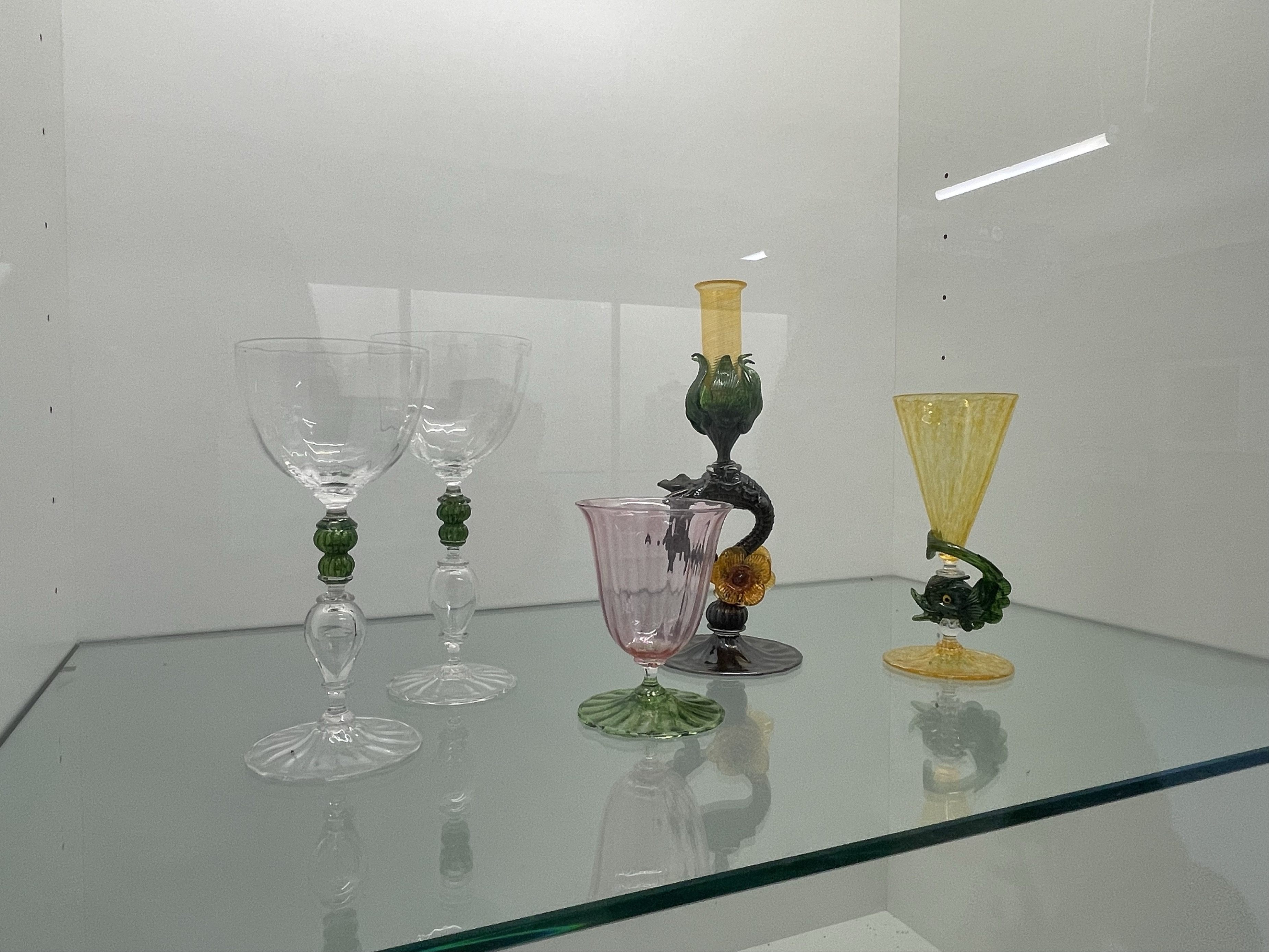 These glass cups were created and placed on display from the glass Crafts & Design program. The materials are glass of different colours put together.