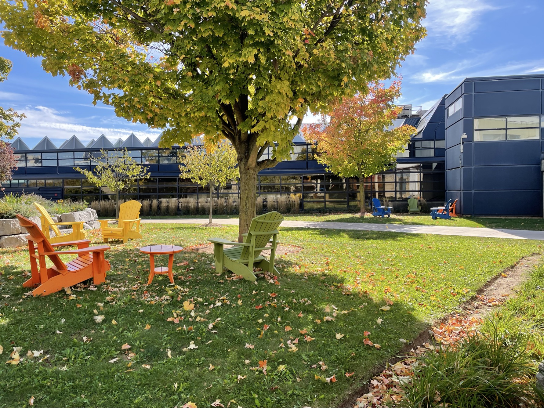 This is the walkway between the AA and A building. It's often used as a place to travel between buildings and relax in when the weather is nice. The materials used are paint, stone, cement, and metal for the pillars.