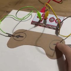 Using a 6B graphite stick, I drew simple buttons onto a game controller shape I cut out. As I'm connected to the ground, the sound triggers when I press the button.